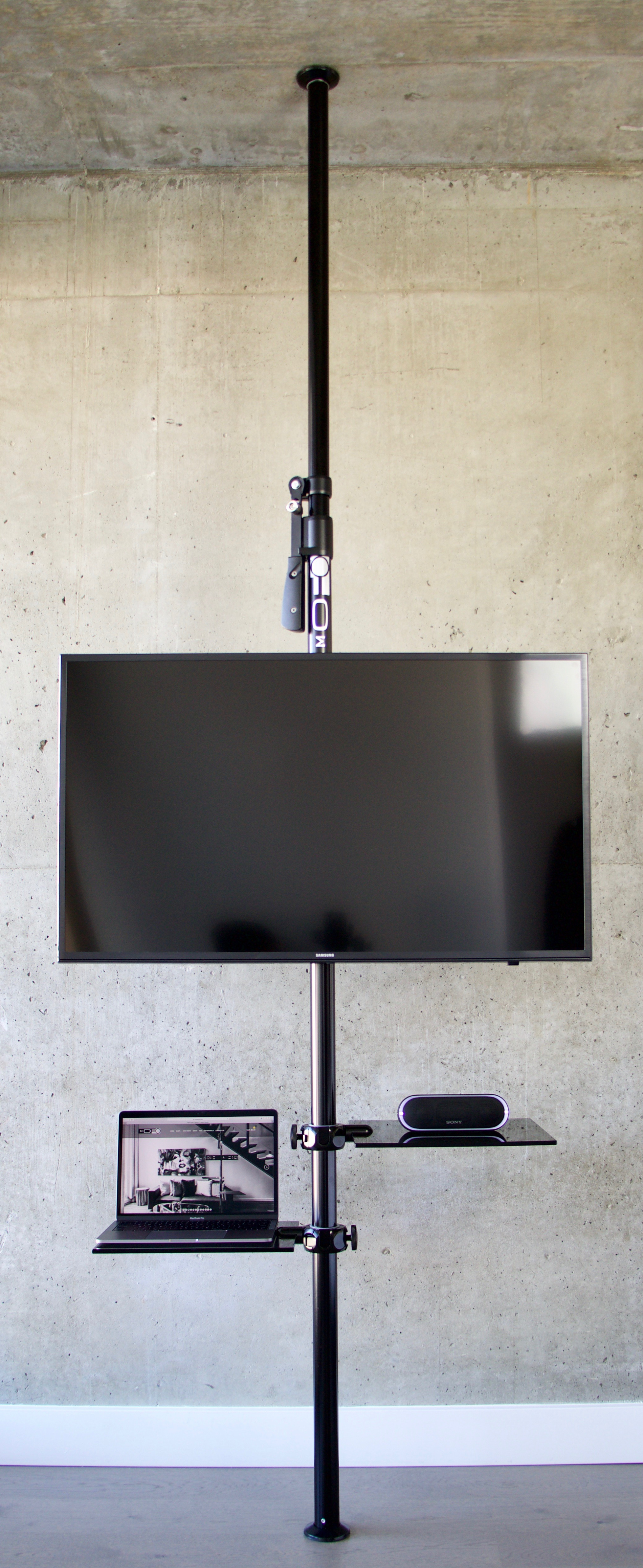 MOFO Pole with two shelves with tv, laptop, and speaker